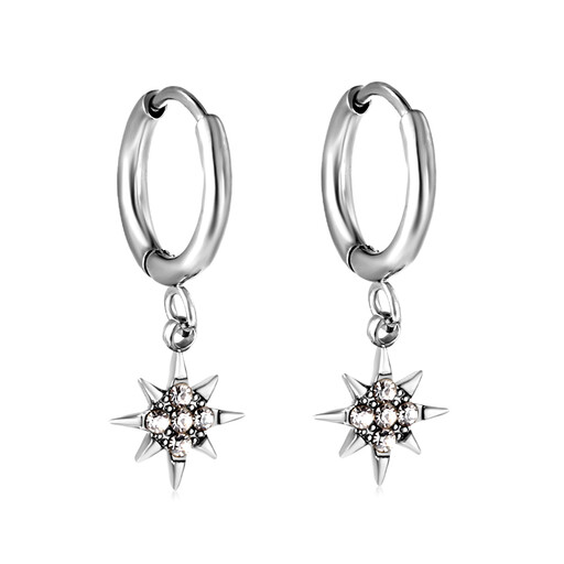 A pair of silver huggie hoop earrings with a starburst or North Star charm dangling from each.