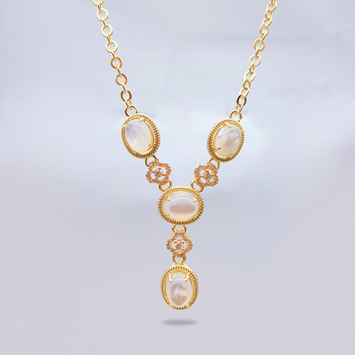An 18K gold plated station necklace with oval charms displayed