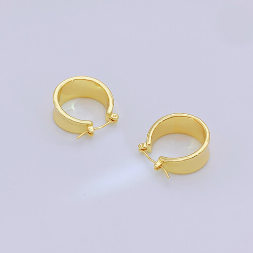 A pair of chunky 20mm gold hoop earrings on a white background