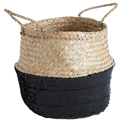 A small, round seagrass basket with a natural top half and a black sequined bottom half, with two loop handles.