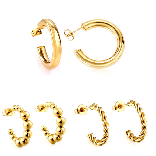 A set of chunky, C-shaped open gold hoop earrings of various sizes