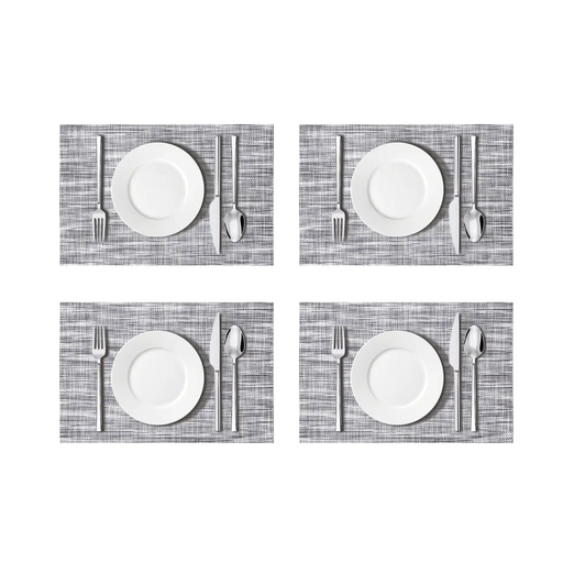 A set of four rectangular placemats with a modern woven texture in a black and grey colour.