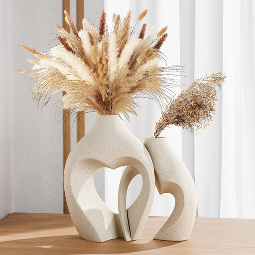 Two white ceramic vases with a heart-shaped hollow centre