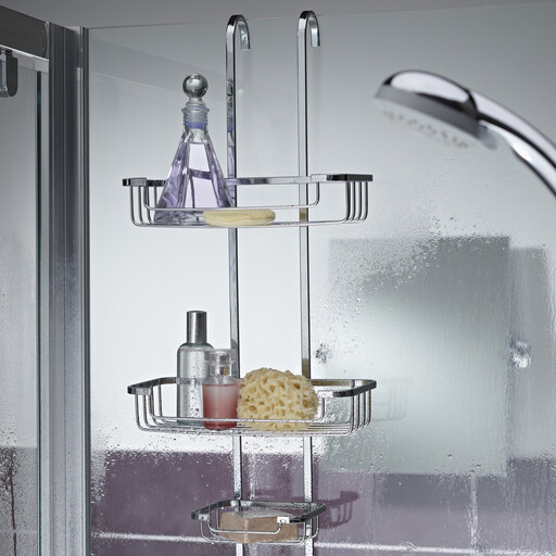 A chrome three-tier storage basket hanging over a door