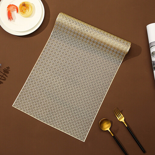 Gold perforated PVC placemat on a dark table