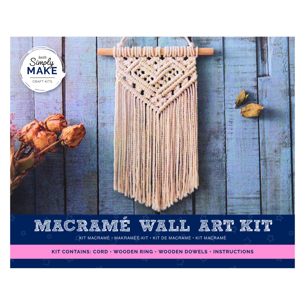 A completed macrame wall hanging with intricate knots and a wooden dowel
