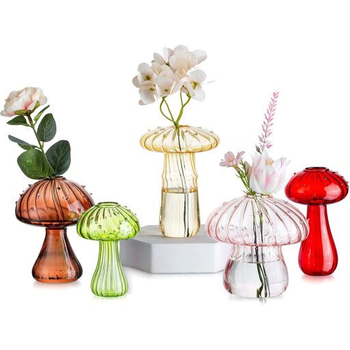 A set of five small, colourful mushroom-shaped glass vases
