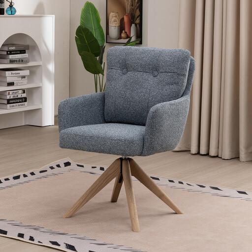 A teal fabric swivel dining chair with a button-tufted back and a wooden star base.