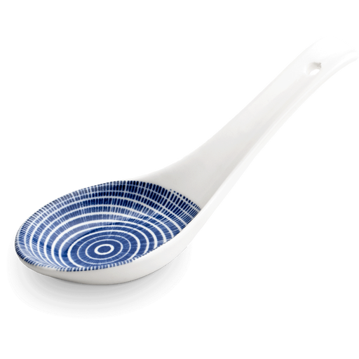 A ceramic spoon with a blue, radiating line pattern on a white background