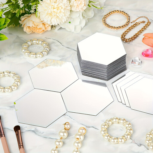 A honeycomb pattern of hexagonal mirror wall stickers on a grey wall
