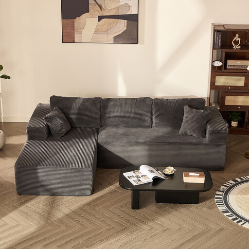 A large, grey L-shaped modular sofa bed in a modern living room