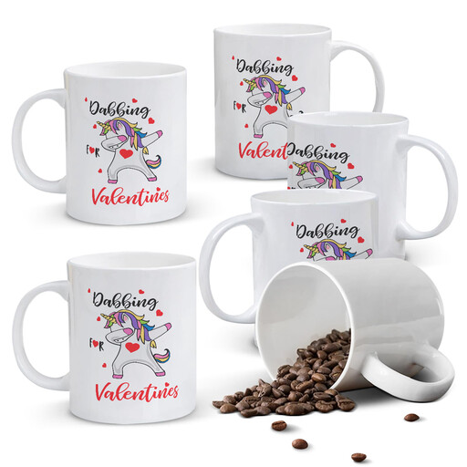 A white ceramic mug with a colourful dabbing unicorn and hearts design