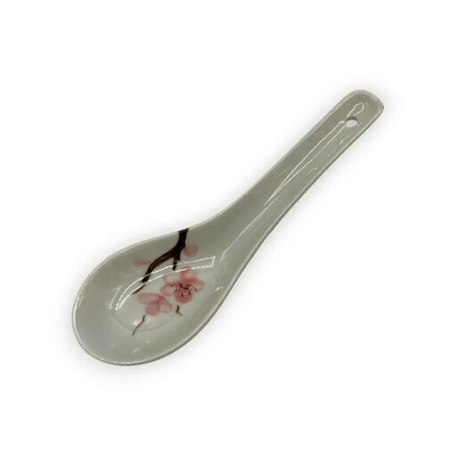 A white ceramic spoon with a pink cherry blossom motif