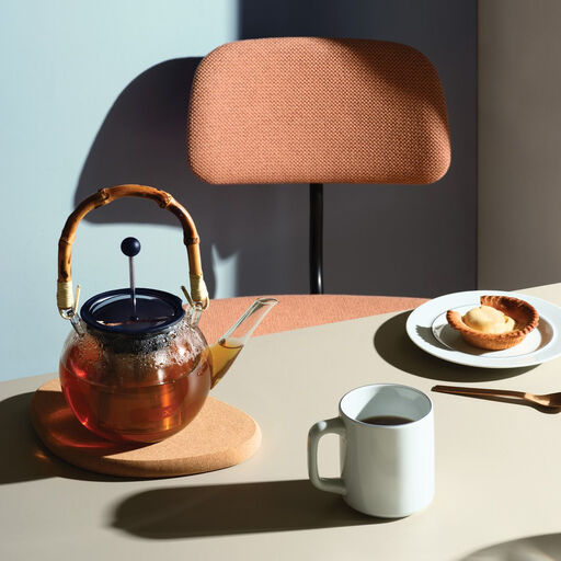 Bodum Assam Tea Press with a distinctive bamboo handle and gooseneck spout.