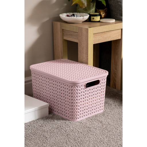 A large, 24-litre blush pink plastic storage basket with a woven texture and a lid, shown on a white background.