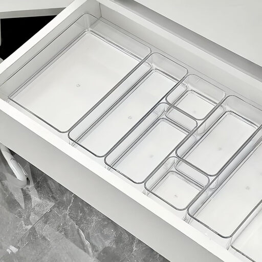 A smaller set of 11 clear plastic drawer organisers in four different sizes