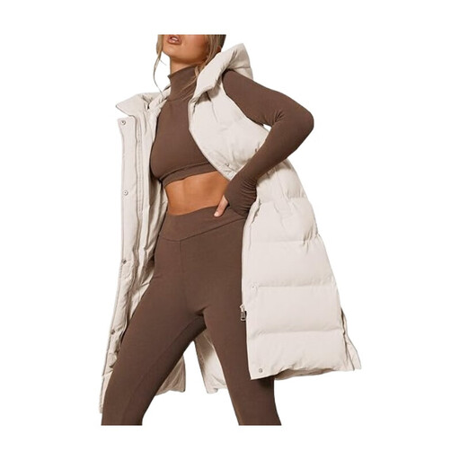 A woman wearing a long beige hooded puffer vest with a stand collar.